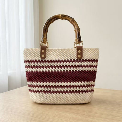 Easy one-stitch DIY crochet purse in wine red and cream striped mercerized yarn with bamboo top handle.