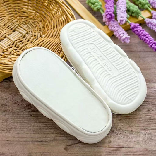 Kids white EVA slipper soles with plush white lining and wave-pattern non-slip bottom for winter crochet slippers.